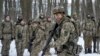 Members of Ukraine's Territorial Defense Forces, volunteer military units of the Armed Forces, train in a city park in Kyiv, Ukraine, Jan. 22, 2022. Dozens of civilians have been joining Ukraine's army reserves in recent weeks amid fears of a Russian inva