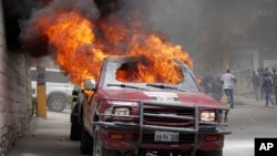 A vehicle that belongs to Radio Tele-Ginen burns during a protest demanding the resignation of President Jovenel Moise in Port-au-Prince, Haiti, June 10, 2019.