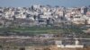 An Israeli military vehicle stands at its position, on the Israeli side of the border with Gaza, Feb. 9, 2025. 