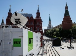 FILE - Vehicles of Russian state-controlled broadcaster RT are seen near Red Square in central Moscow, Russia, June 15, 2018.