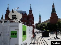 FILE - Vehicles of Russian state-controlled broadcaster RT are seen near Red Square in central Moscow, Russia, June 15, 2018.