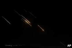 Missiles launched from Iran towards Israel are seen in the West Bank city of Nablus, Oct. 1, 2024.