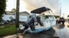 A boat rests on a street after being relocated during flooding caused by Hurricane Helene, Sept. 27, 2024, in Hudson, Florida.