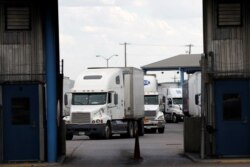 FILE - Trucks are seen after crossing the border from Mexico into the U.S. at the World Trade Bridge, in Laredo, Texas, June 20, 2019.