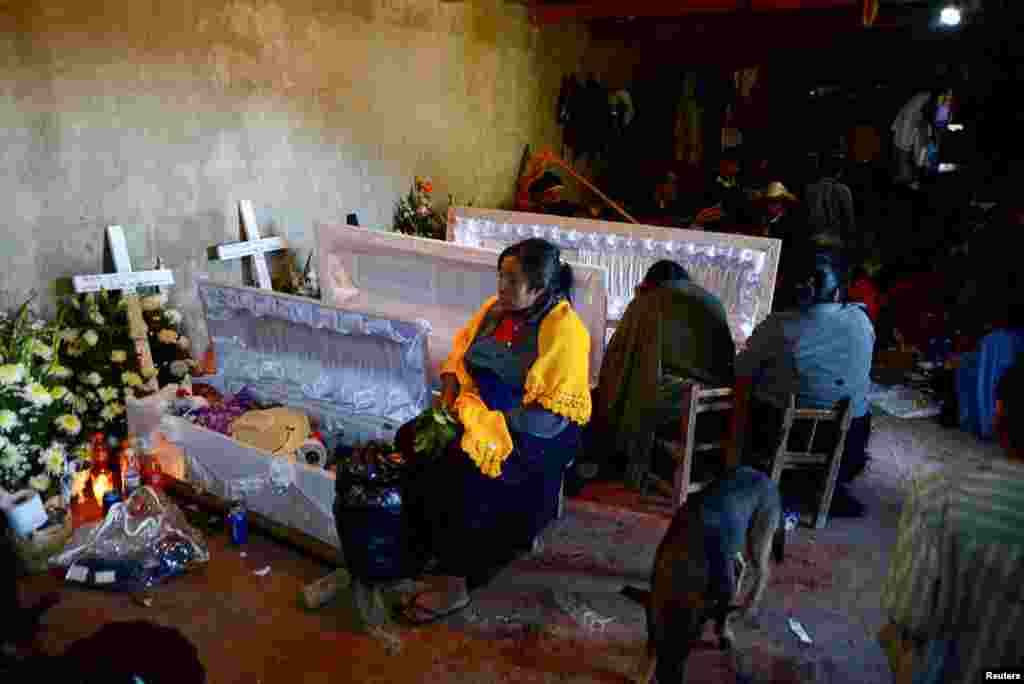 Women take part in a wake for their loved ones, who died during a landslide caused by Tropical Storm Eta, in the village of Mukem, Chiapas state, Mexico, Nov. 9, 2020.