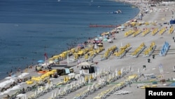 FILE - Tourists enjoy a beach in the Mediterranean resort city of Antalya, a popular destination for German tourists, in Turkey, July 25, 2016.