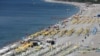 Tourists enjoy a beach in the Mediterranean resort city of Antalya, a popular destination for German tourists, in Turkey, July 25, 2016.