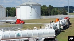 FILE - Tanker trucks line up at a Colonial Pipeline Co. facility in Pelham, Ala., Sept. 16, 2016. 