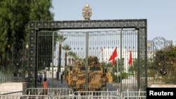 A military vehicle is parked in front of the parliament building in Tunis, Tunisia July 26, 2021. 