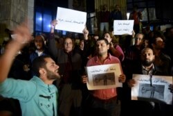 FILE - Journalists chant slogans in front of the Journalists Syndicate in Cairo, Nov. 19, 2016, to protest the sentencing of the head of the union and two members to two years in prison.