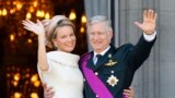 King Philippe of Belgium and Queen Mathilde salute the crowd from the balcony of the Royal Palace in Brussels, July 21, 2013. Belgium is celebrating its National Day, which also marks the abdication of King Albert II and the investiture of his eldest son Philippe.