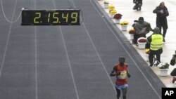 Daniel Ndiritu Gatheru of Kenya finishes third the Athens Classic Marathon at the Panathinaikon Stadium in Athens, on Sunday, Nov. 13, 2011. About 18,000 people took part in the marathon and two shorter races of 5 kms and 10 kms as the race was run in c