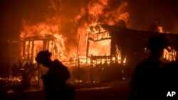 Flames from a wildfire consume a residence near Oroville, California, July 9, 2017. Evening winds drove the fire through several neighborhoods leveling homes in its path. 