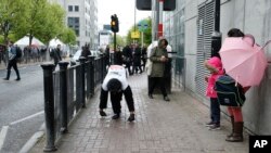 Tom Harrison, also known as Mr. Gorilla, makes his way crawling along part of the London Marathon course in a bid to support the charity "Gorilla Organization," in London, April 27, 2017.