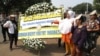 Protesters hold a placard during a rally, opposing a regional election bill in front of palace in Jakarta, Monday, Sept 29, 2014.