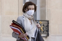 FILE - French Defense Minister Florence Parly, wearing a protective face mask, leaves after a weekly Cabinet meeting at The Elysee Presidential Palace in Paris on March 31, 2021.