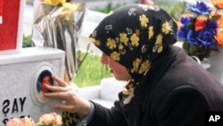 A Turkish girl cries while touching a picture of her brother on a decorated gravestone at a cemetery in Istanbul. The girl's brother was one of the Turkish soldiers who lost their lives in clashes against Kurdish rebels (File).