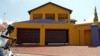 A boy cycles in front of a house in the upmarket Diepkloof extention in Soweto, South Africa, February 2006 file photo. 