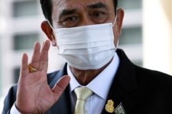 Thai Prime Minister Prayuth Chan-ocha waves as he attends an agreement signing ceremony for purchase of AstraZeneca's potential COVID-19 vaccine at Government House, amid the spread of the coronavirus disease (COVID-19), in Bangkok, Nov. 27, 2020.