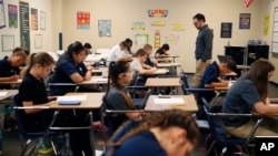 In this Nov. 16, 2017, photo, students take a quiz in Michael Briggs' seventh grade algebra class at Lake Mead Christian Academy in Henderson, Nev. (AP Photo/John Locher)