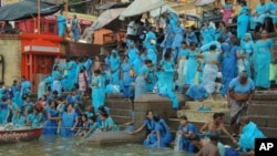 Balmik women, considered 'untouchables' in India, take a dip for the first time in river Ganges in Varanasi, India, June, 2011.