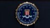 FILE - In this June 14, 2018, file photo, the FBI seal is seen before a news conference at FBI headquarters in Washington. The FBI is grappling with a seemingly endless cycle of money laundering schemes that law enforcement officials say they’re…