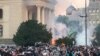 Serbia, Belgrade, Demonstrators stand among tear gas during an anti-government rally, amid the spread of the coronavirus disease