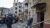 Residents are seen near a building destroyed by a Russian missile strike in Kramatorsk, Ukraine February 2, 2023. (Vyacheslav Madiyevskyy/Reuters)