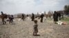 A girl carries food aid she received from the local charity, Mona Relief, on the outskirts of Sana'a, Yemen, May 5, 2019.