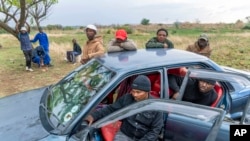 Relatives of miners and community members wait near the shaft of a closed mine where illegal miners are inside in Stilfontein, South Africa, Nov. 14, 2024. 