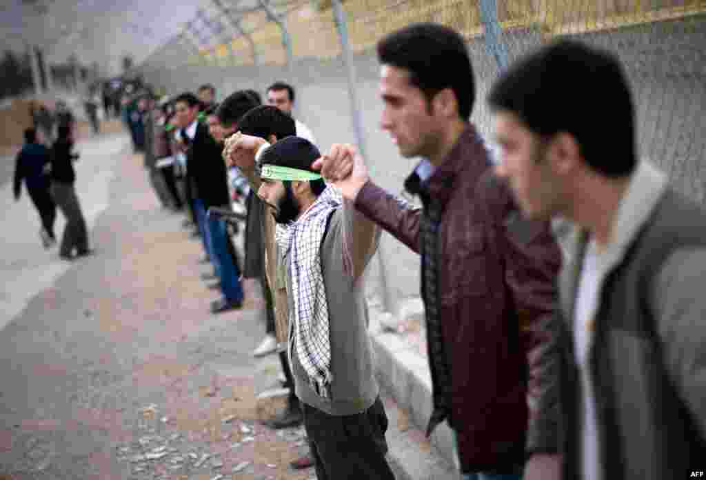 Iranian students form a human chain around the Uranium Conversion facility to show their support for Iran's nuclear program in Isfahan, Iran, November 15, 2011. (Reuters)