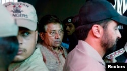 Pakistan's former president and head of the All Pakistan Muslim League (APML) political party Pervez Musharraf (C) is escorted by security officials as he leaves an anti-terrorism court in Islamabad, April 20, 2013. 