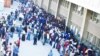 Zimbabweans gather and queue outside a Home Affairs Department office in South Africa to apply for new residence permits