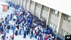 Zimbabweans gather and queue outside a Home Affairs Department office in South Africa to apply for new residence permits