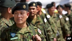 FILE - Members of the Japan Self-Defense Forces arrive at the airport in Juba, South Sudan, Nov. 21, 2016. Japanese peacekeepers, with a broader mandate to use force, landed in South Sudan in the first such deployment of the country's troops overseas with