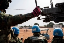 FILE Rwandan MINUSCA peacekeeping forces patrol outside Bangui, Central African Republic, Jan. 23, 2021.