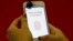 A promoter demonstrates the fingerprint scanner feature of the newly launched Apple iPhone 5S in Singapore, Sept. 20, 2013. 