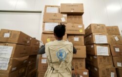 FILE - A World Food Program worker arranges relief packages for humanitarian aid for Africa to combat the outbreak of the coronavirus disease, at the Bole International Airport in Addis Ababa, Ethiopia, April 14, 2020.