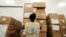 FILE - A World Food Program worker arranges relief packages for humanitarian aid for Africa to combat the outbreak of the coronavirus disease, at the Bole International Airport in Addis Ababa, Ethiopia, April 14, 2020. 