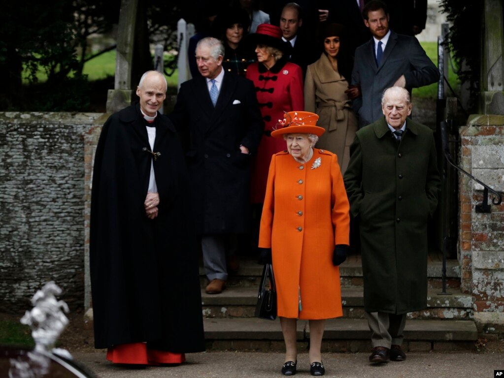 Britain's Queen Elizabeth II, center, with Prince Philip, right, leave following the traditional Christmas Day church service, at St. Mary Magdalene Church in Sandringham, Dec. 25, 2017.