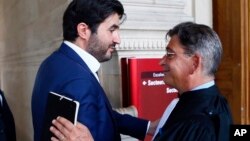 French financier Nadav Bensoussan, left, discusses with his lawyer Jean Marc Fedida as he leaves the Palais de Justice courthouse in Paris, France, after he was sentenced to serve two years in prison, July 6, 2017. 