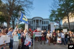 A crowd of around 500 people protested a bill permitting service denial to gays outside the governor's office during a rally in Jackson, Mississippi, April 4, 2016.