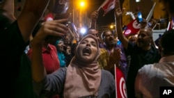 Supporters of the Islamist party Ennahda react as they follow exit polls in Tunis, Tunisia, Oct. 6, 2019. 