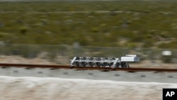 FILE - A sled speeds down a track during a test of a Hyperloop One propulsion system in North Las Vegas, Nevada, May 11, 2016.