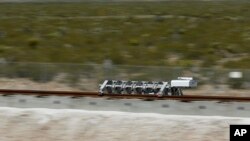 FILE - A sled speeds down a track during a test of a Hyperloop One propulsion system in North Las Vegas, Nevada, May 11, 2016.