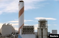 FILE - A facility for capturing CO2 from air of Swiss Climeworks AG is placed on the roof of a waste incinerating plant in Hinwil, Switzerland, July 18, 2017.