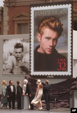 Postal and film industry officials view the unveiling of the new James Dean stamp at a ceremony, June 24, 1996 on the lot where Dean filmed "East of Eden" and "Rebel Without a Cause," at Warner Bros. Studios in Burbank, Calif.