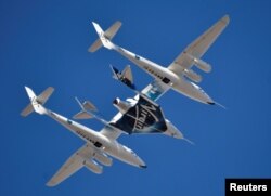 FILE - Virgin Galactic rocket plane, the WhiteKnightTwo carrier airplane, with SpaceShipTwo passenger craft takes off from Mojave Air and Space Port in Mojave, Calif., Feb. 22, 2019.