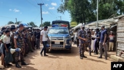 Law enforcement personnel arrive at Kitupalong Refugee camp in Ukhia on Sept. 30, 2021, a day after an unidentified assailant shot dead refugee leader Mohib Ullaha outside his office in a refugee camp.