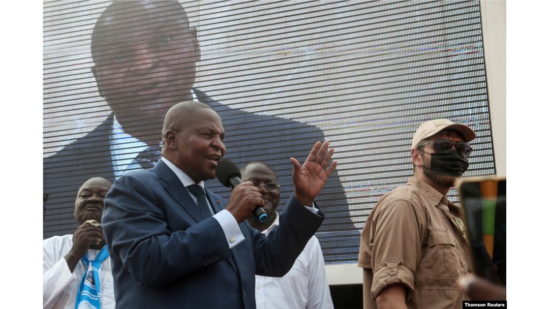 FILE - President Faustin-Archange Touadera greets supporters after highest court confirmed his re-election at his party headquarter in Bangui.